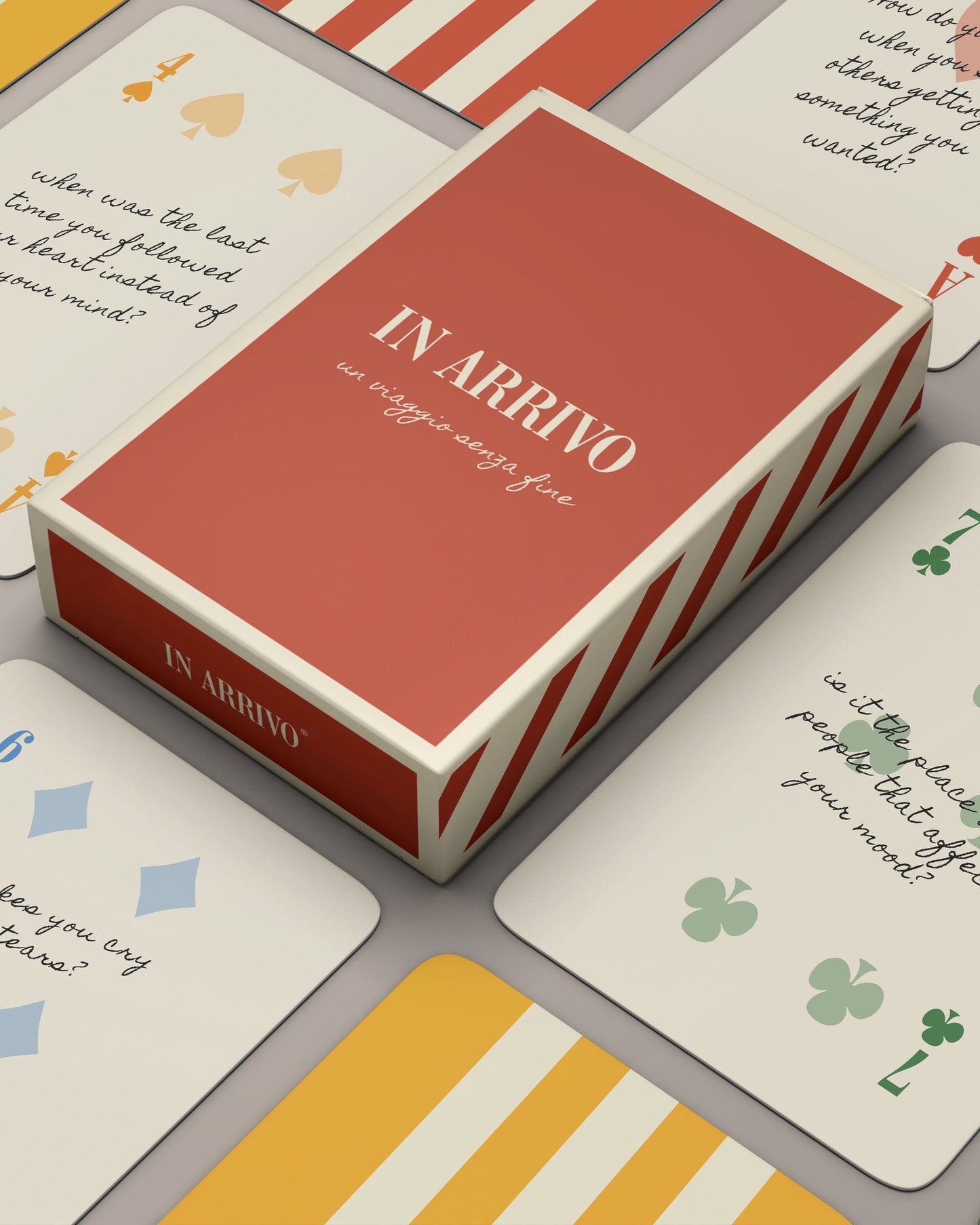 A deck of playing cards with various face cards visible, scattered in a casual layout on a light background.