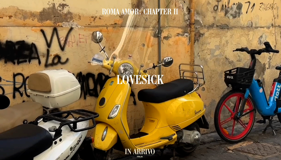 Yellow scooter with 'Lovesick' branding against a graffiti-covered wall.